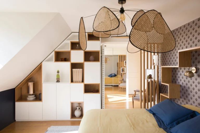 Placard sur mesure sous pente blanche avec niches en bois clair dans une chambre mansardée